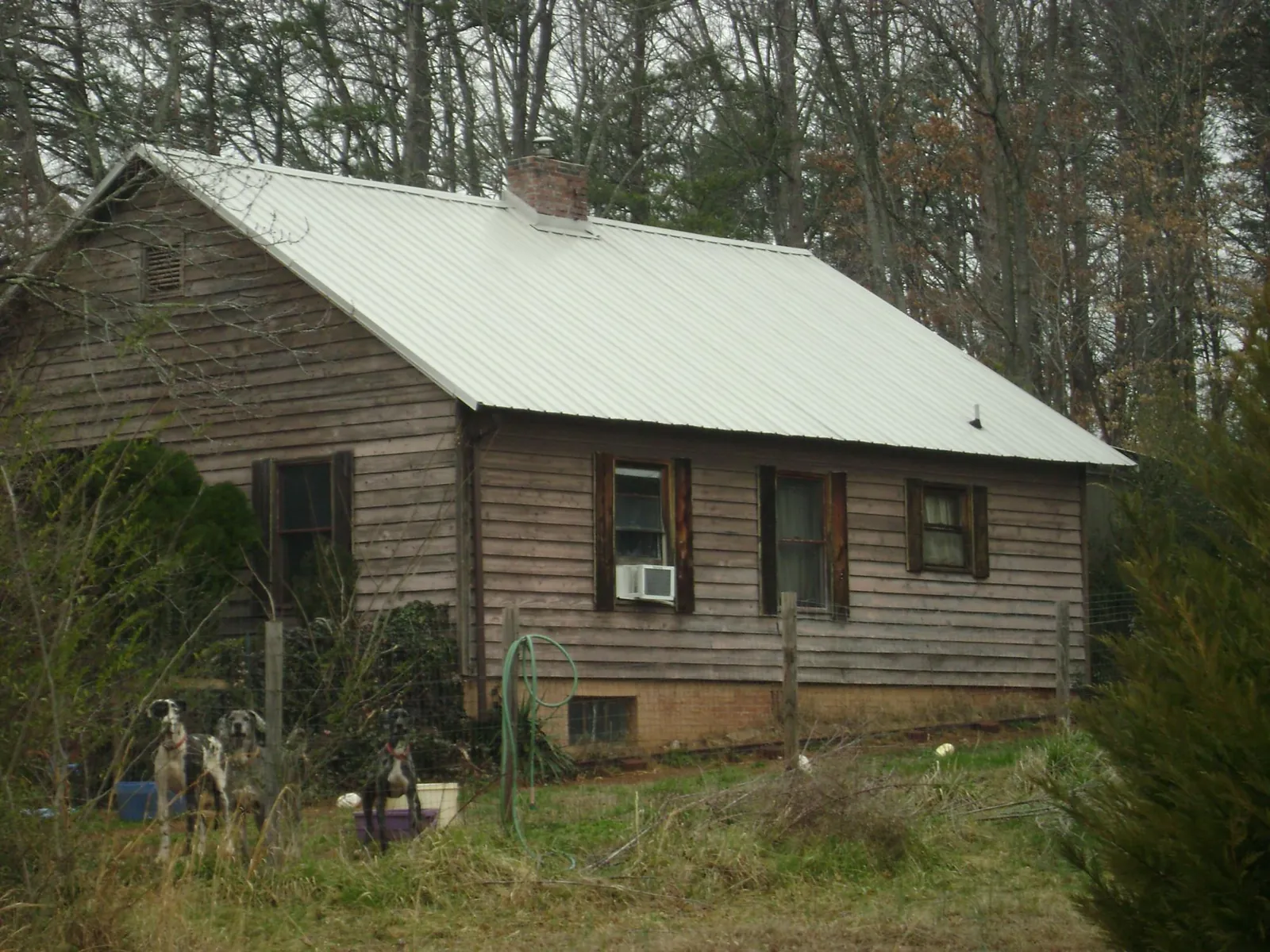 White metal roof on an old wood sided farmhouse, from a Metal Roof Installation job in Saint Donatus